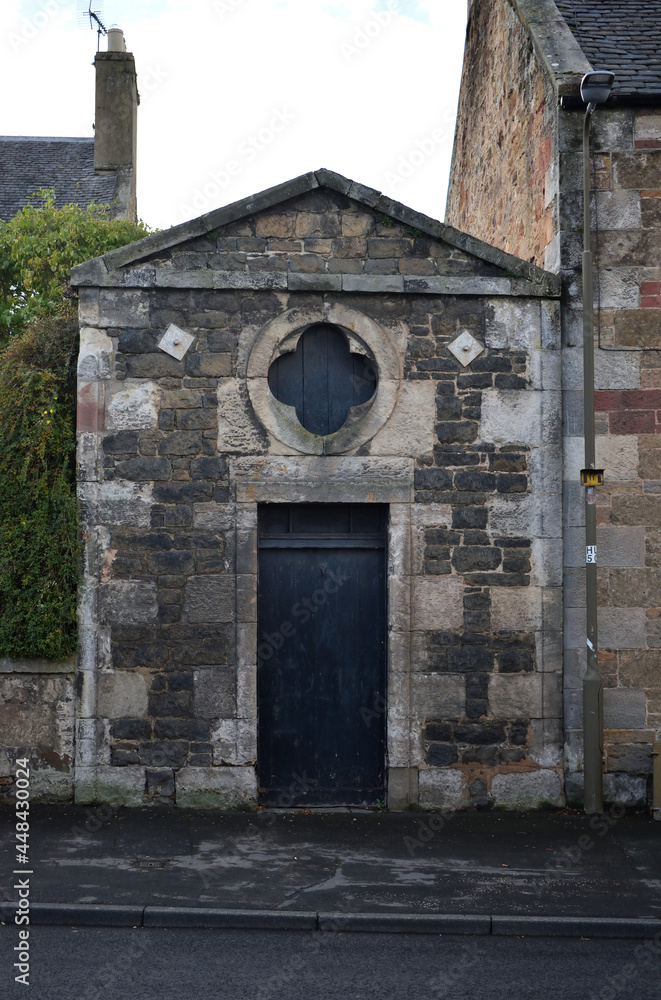 Fototapeta premium Street Facade of Old Stone Classical Building with Pediment-Door & Round Window
