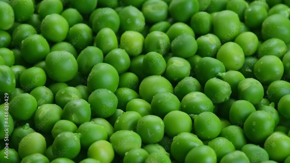 Fresh green pods or peas rotating. Peas background. Top view Fresh green pods or peas rotating. Peas background. Top view