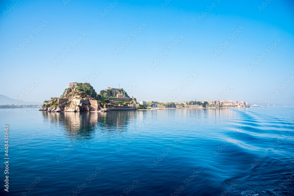 View of the fortress of Corfu from the sea in the morning mist with a trace of waves from the ferry. popular tourist attractions. amazing places.