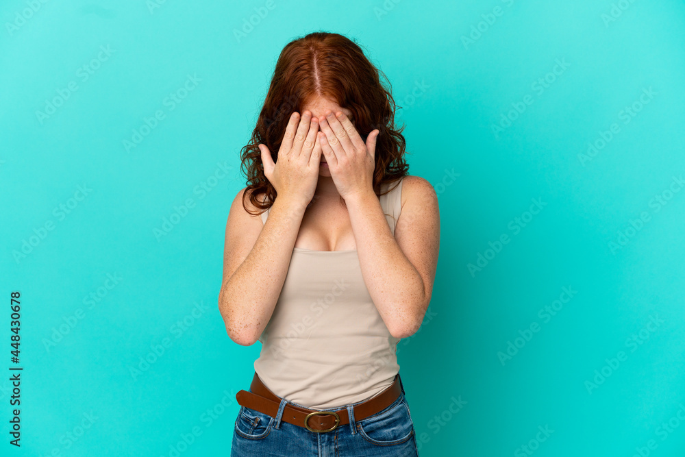 Teenager reddish woman isolated on blue background with tired and sick expression Teenager reddish woman isolated on blue background with tired and sick expression