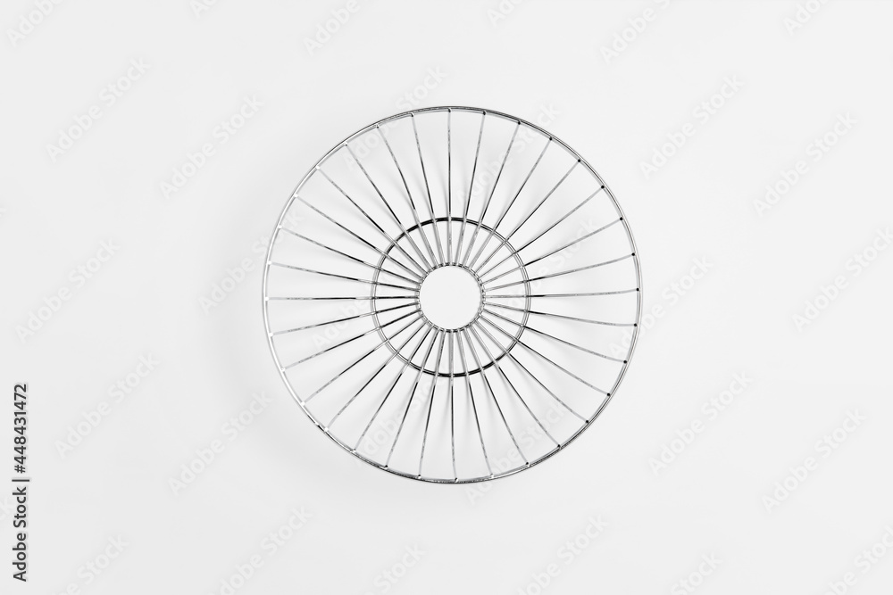 Modern style fruit basket made of steel wire isolated on white background.High-resolution photo.Top view. Mock-up.