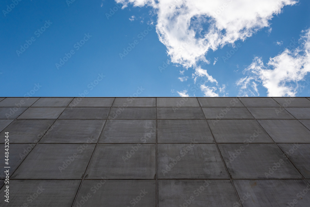 view up to a concrete wall and the blue sky 