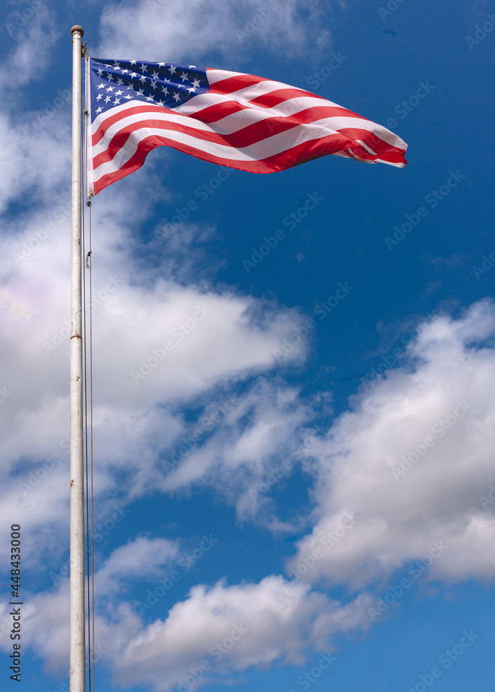 Fototapeta premium American flag and sky on a windy day.