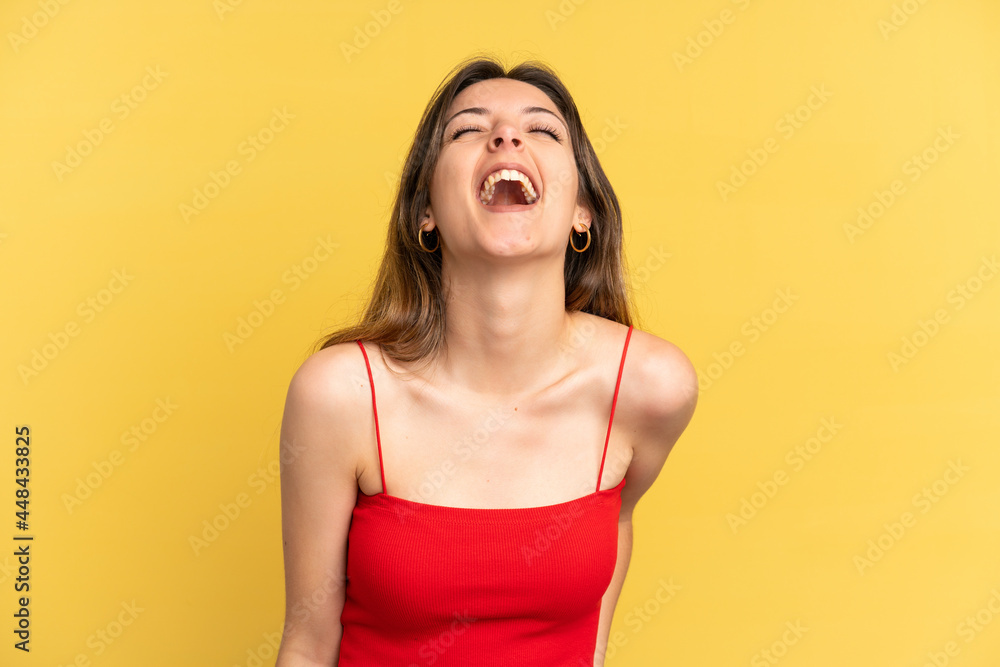 Young caucasian woman isolated on yellow background shouting to the front with mouth wide open Young caucasian woman isolated on yellow background shouting to the front with mouth wide open