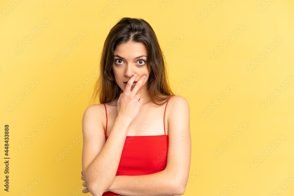 Young caucasian woman isolated on yellow background surprised and shocked while looking right Young caucasian woman isolated on yellow background surprised and shocked while looking right