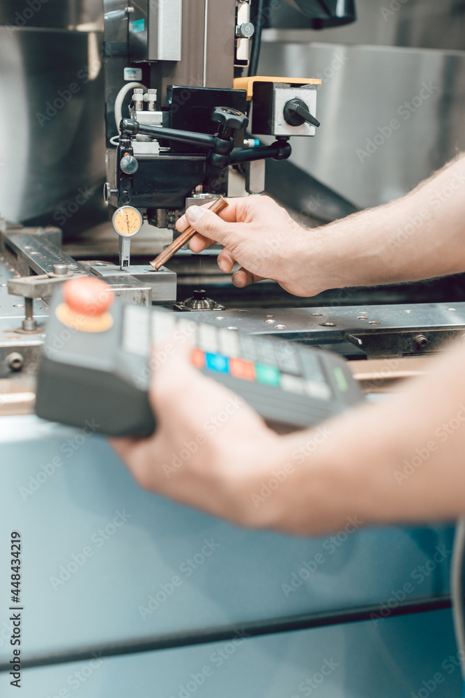 Close-up of Worker in factory putting tool into a punching machine Close-up of Worker in factory putting tool into a punching machine