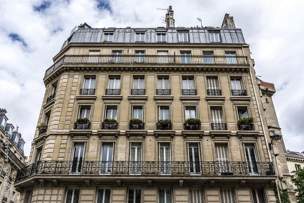Traditional French old house with typical balconies and windows. Paris, France.