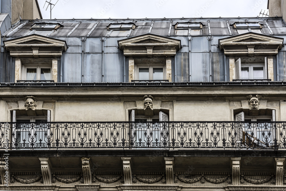 Traditional French old house with typical balconies and windows. Paris, France.