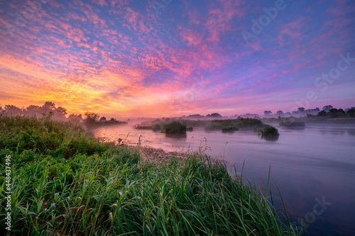 Fotografie Colorful sunrise over the river banks