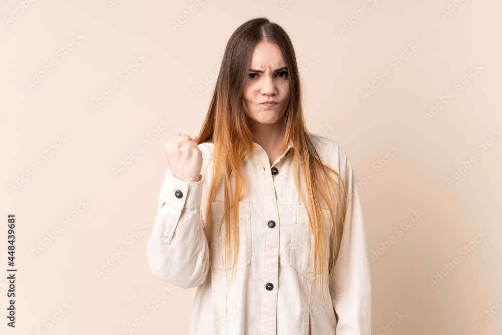 Young caucasian woman isolated on beige background with unhappy expression Young caucasian woman isolated on beige background with unhappy expression
