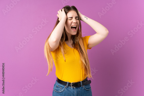Young caucasian woman isolated on purple background stressed overwhelmed