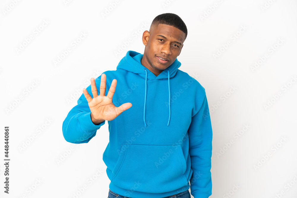 Young latin man isolated on white background counting five with fingers Young latin man isolated on white background counting five with fingers