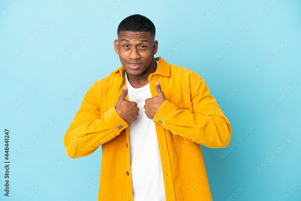 Young latin man isolated on blue background with surprise facial expression Young latin man isolated on blue background with surprise facial expression
