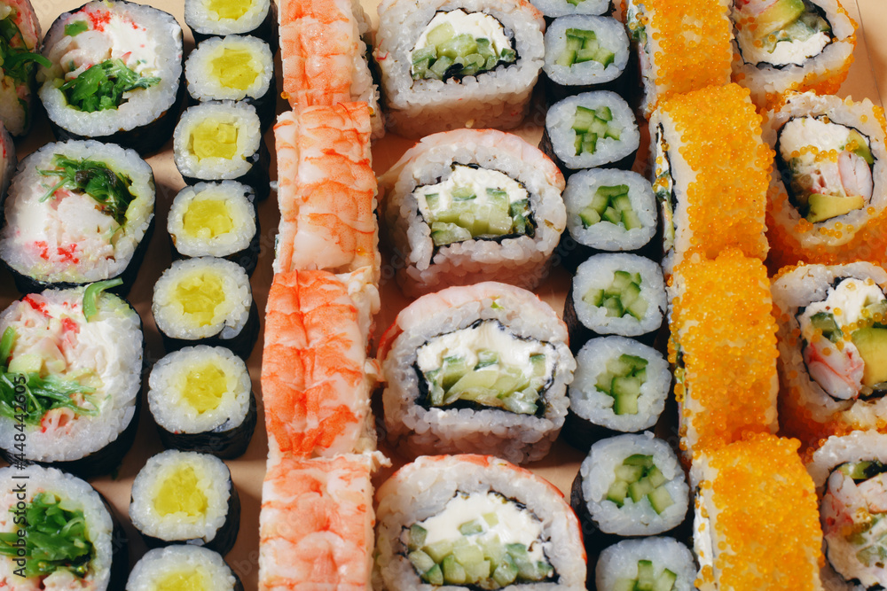 Maki and nigiri, sushi with fish, fresh salmon, shrimp and cheese, avocado rolls. Futomaki and Philadelphia with California. Set sushi Maki and nigiri, sushi with fish, fresh salmon, shrimp and cheese, avocado rolls. Futomaki and Philadelphia with California. Set sushi