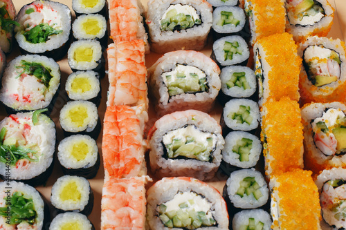 Maki and nigiri, sushi with fish, fresh salmon, shrimp and cheese, avocado rolls. Futomaki and Philadelphia with California. Set sushi