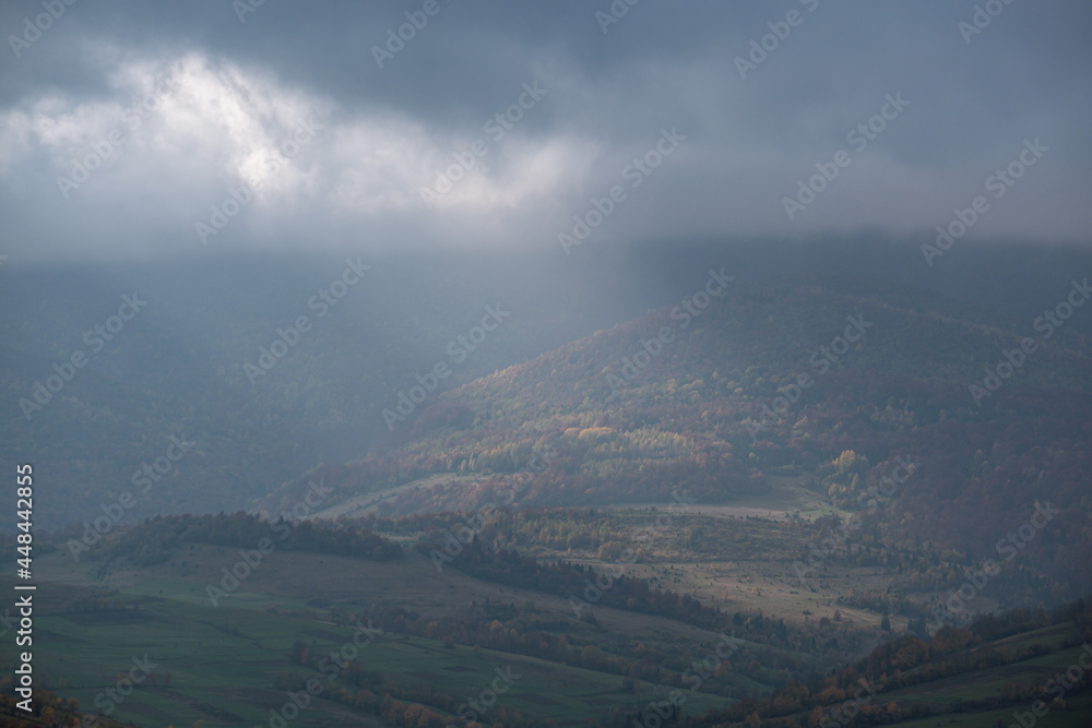 Morning foggy clouds in sunlight and autumn mountain countryside. Ukraine, Carpathian Mountains, Borzhava Range, Transcarpathia. Morning foggy clouds in sunlight and autumn mountain countryside. Ukraine, Carpathian Mountains, Borzhava Range, Transcarpathia.