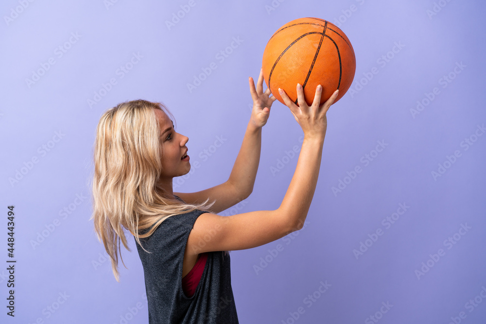 Young Russian woman isolated on purple background playing basketball Young Russian woman isolated on purple background playing basketball