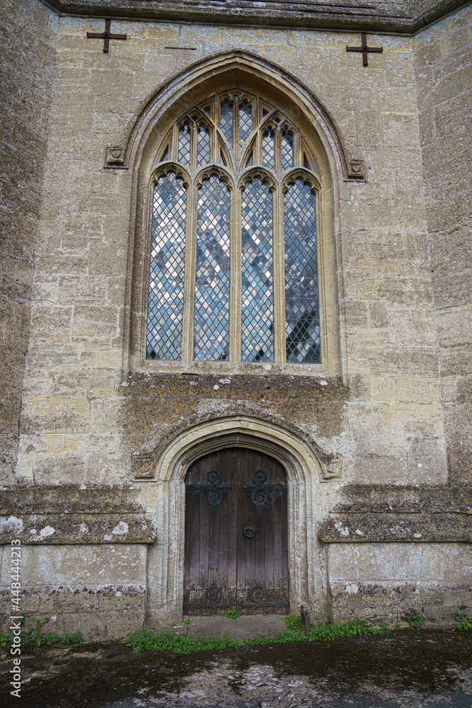 beautiful detailed church window with stained glass and arched stone work and mullions