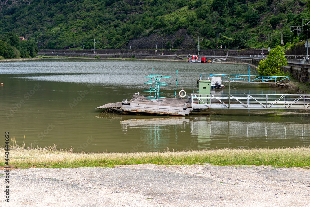 Obraz premium A metal platform protruding from the river bank on air tanks, a pier to the entrance to the ship.