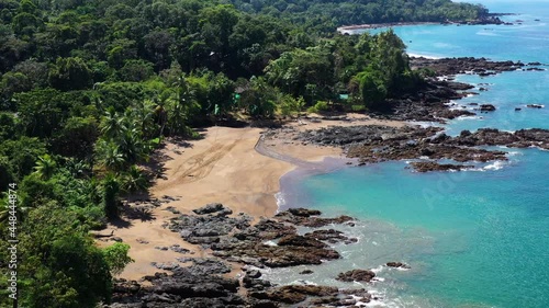 Palm trees along sandy beach and blue water tropical jungle forest Corcovado park aerial Costa Rica sunny day  photo