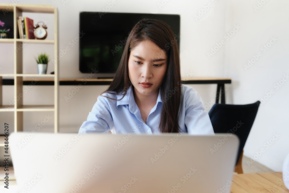A company employee shows a bored expression on his or her job while working in the office. A company employee shows a bored expression on his or her job while working in the office.