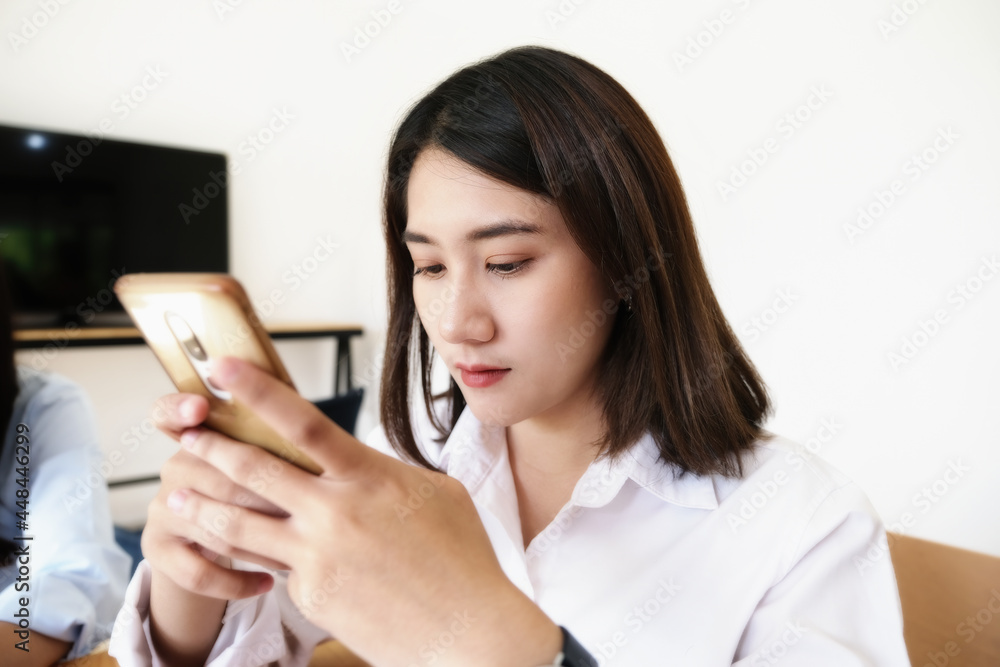woman using mobile phone to social media in office. woman using mobile phone to social media in office.