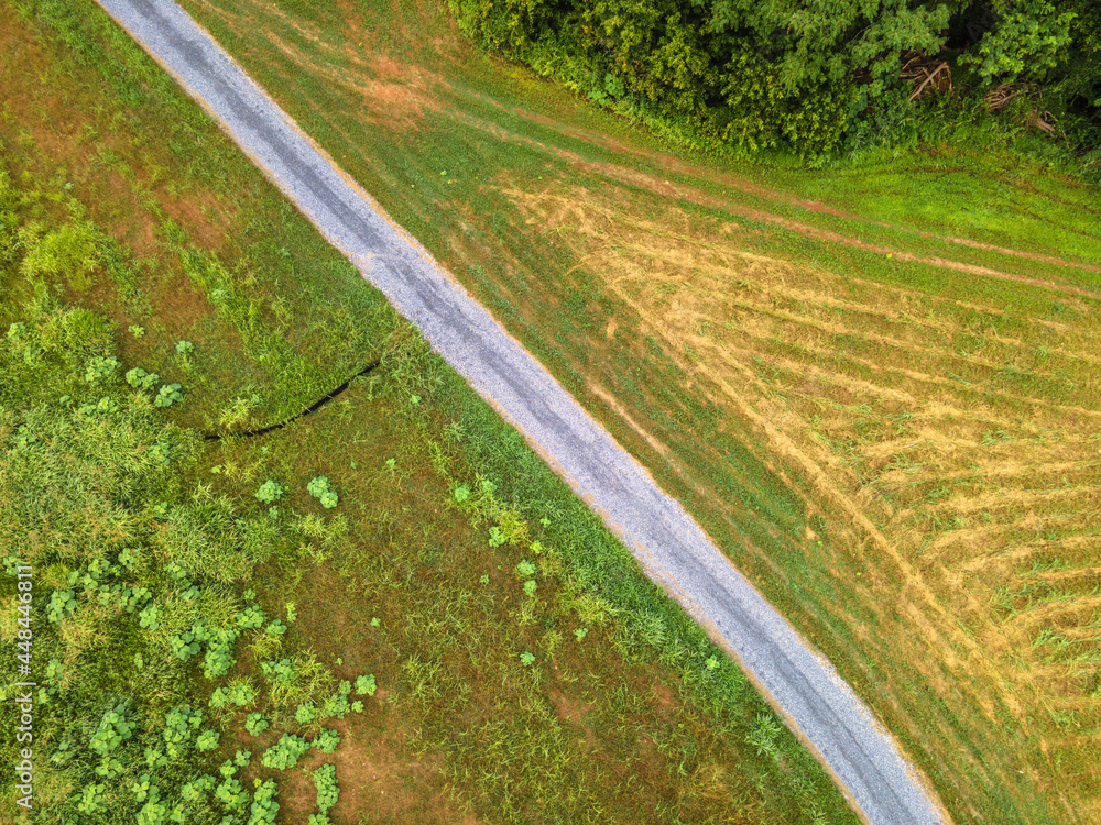 rural gravel road in the field drone view