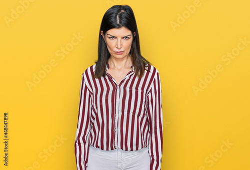 Beautiful brunette woman wearing striped shirt skeptic and nervous, frowning upset because of problem. negative person. © Krakenimages.com