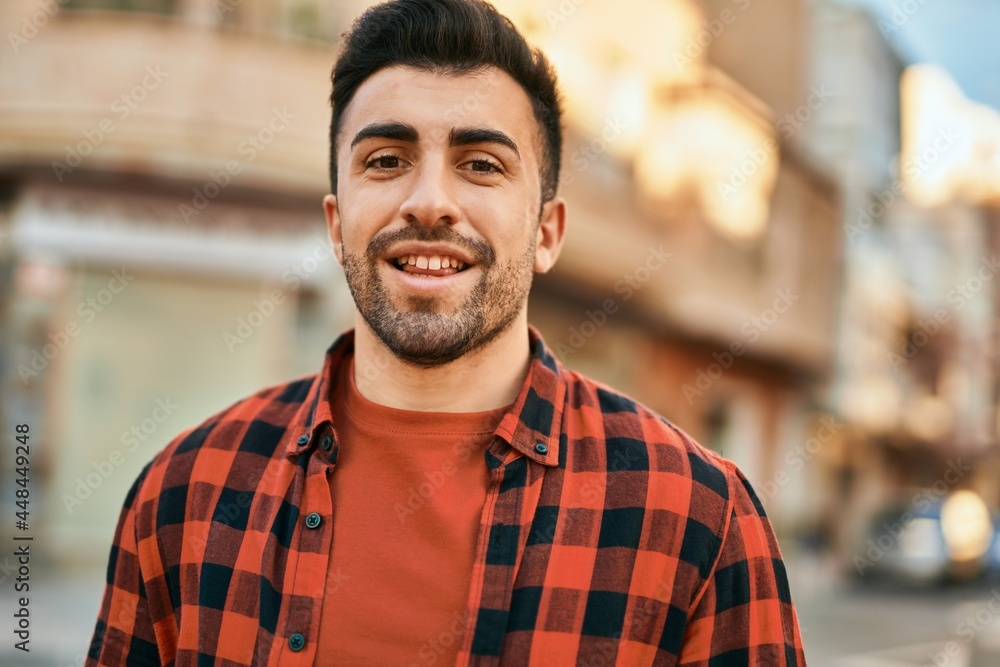 Young hispanic man smiling happy standing at the city. Young hispanic man smiling happy standing at the city.