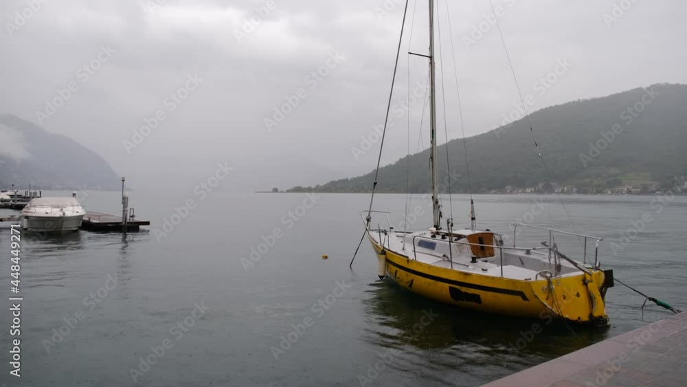 Boats pitch at anchor on the quay - Raindrops on the lake Boats pitch at anchor on the quay - Raindrops on the lake