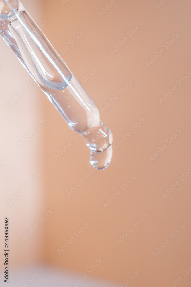 A drop of cosmetic oil falls from the pipette A drop of cosmetic oil falls from the pipette