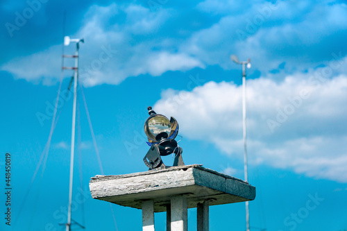 spherical meteorological sunshine recorder (heliograph) at the weather station against the sky photo