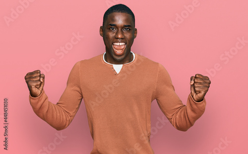 Young african american man wearing casual clothes screaming proud, celebrating victory and success very excited with raised arms