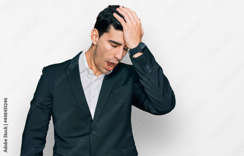 Handsome hispanic man wearing business clothes surprised with hand on head for mistake, remember error. forgot, bad memory concept. Handsome hispanic man wearing business clothes surprised with hand on head for mistake, remember error. forgot, bad memory concept.