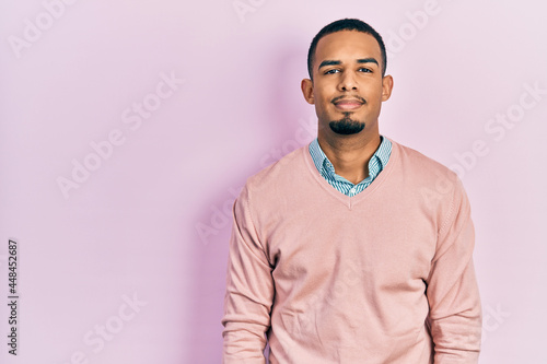 Young african american man wearing elegant clothes with serious expression on face. simple and natural looking at the camera.