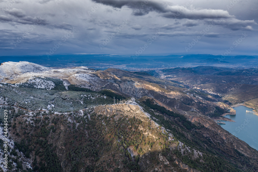 Aerial landscape shot of a snowy Sierra Nevada mountains Granada, Andalucia, Spain