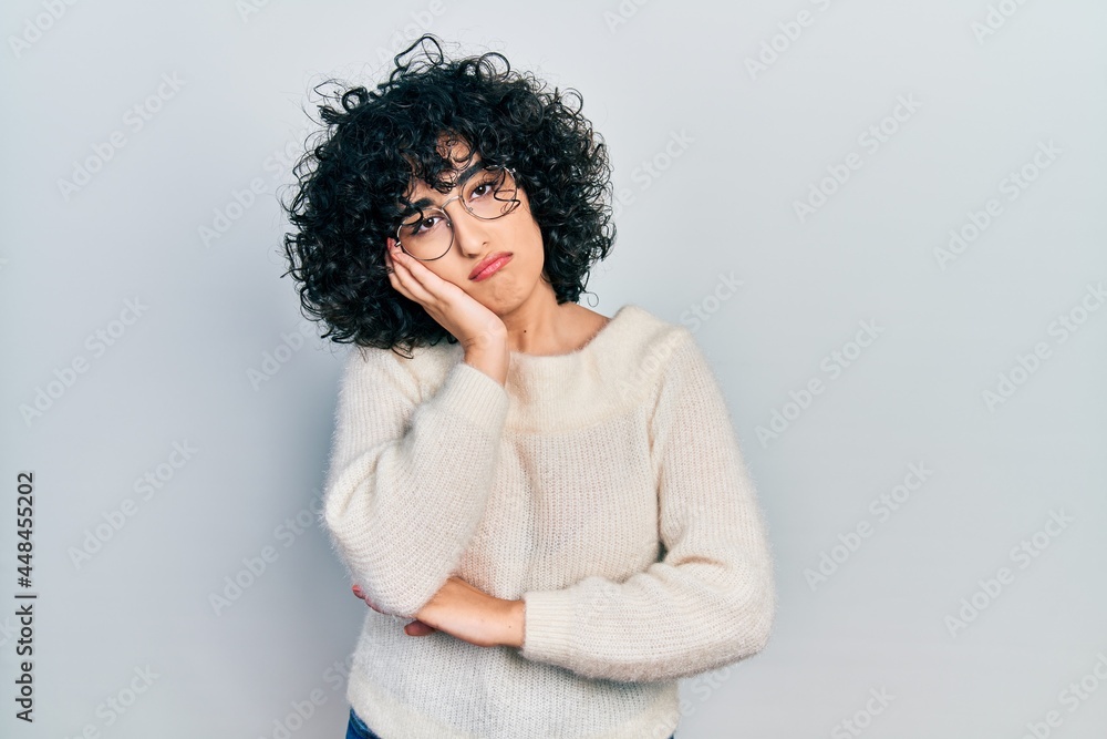 Young middle east woman wearing casual white tshirt thinking looking tired and bored with depression problems with crossed arms. Young middle east woman wearing casual white tshirt thinking looking tired and bored with depression problems with crossed arms.