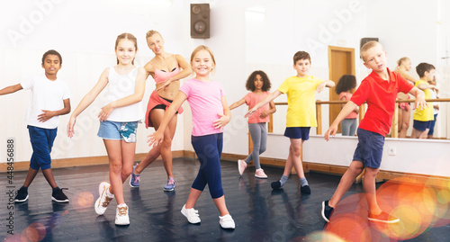 Fototapeta Naklejka Na Ścianę i Meble -  Dance class for kids, positive girls and boys training in dance studio