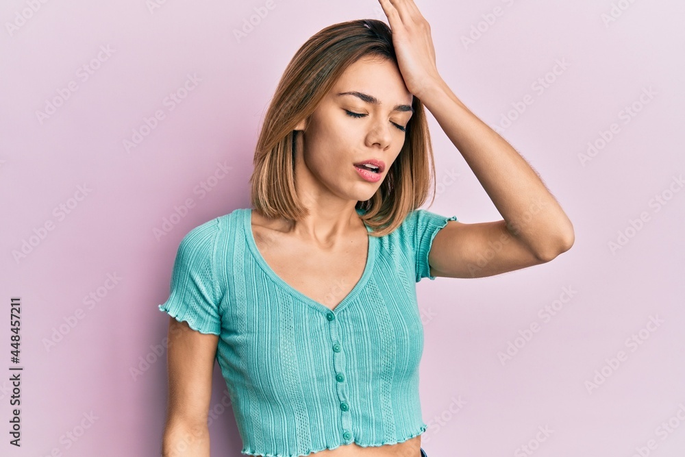 Young caucasian blonde woman wearing casual blue t shirt surprised with hand on head for mistake, remember error. forgot, bad memory concept. Young caucasian blonde woman wearing casual blue t shirt surprised with hand on head for mistake, remember error. forgot, bad memory concept.