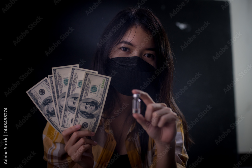 Asian women wear a mask because they are patients infected with the Covid-19 virus. Was sitting in a dimly lit room and she was depressed, wanting to commit suicide and taking dangerous drugs. Asian women wear a mask because they are patients infected with the Covid-19 virus. Was sitting in a dimly lit room and she was depressed, wanting to commit suicide and taking dangerous drugs.