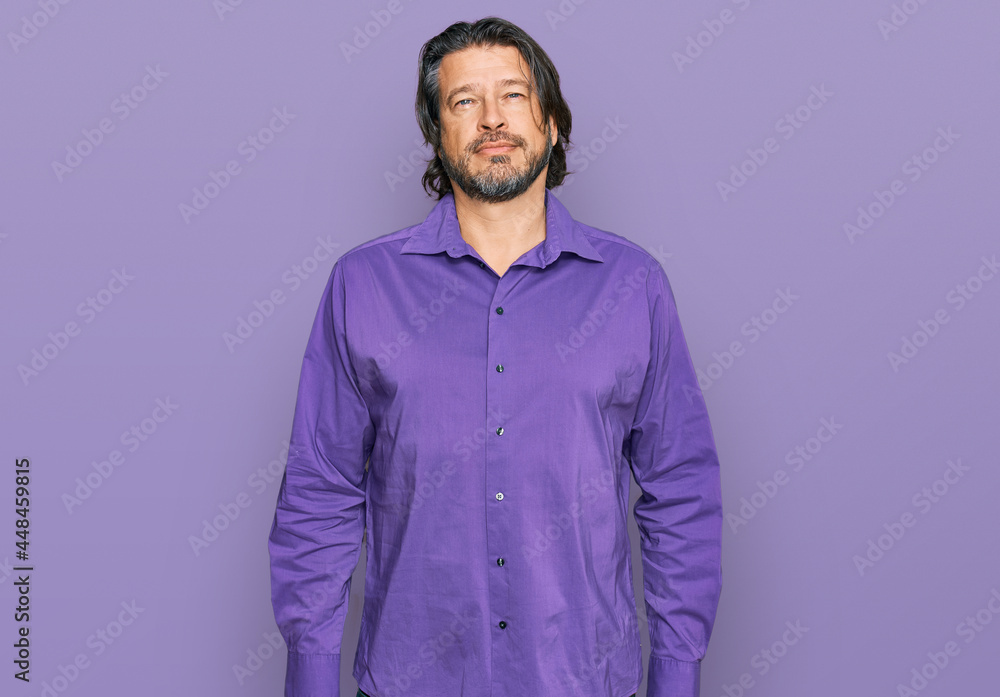 Middle age handsome man wearing business shirt relaxed with serious expression on face. simple and natural looking at the camera.