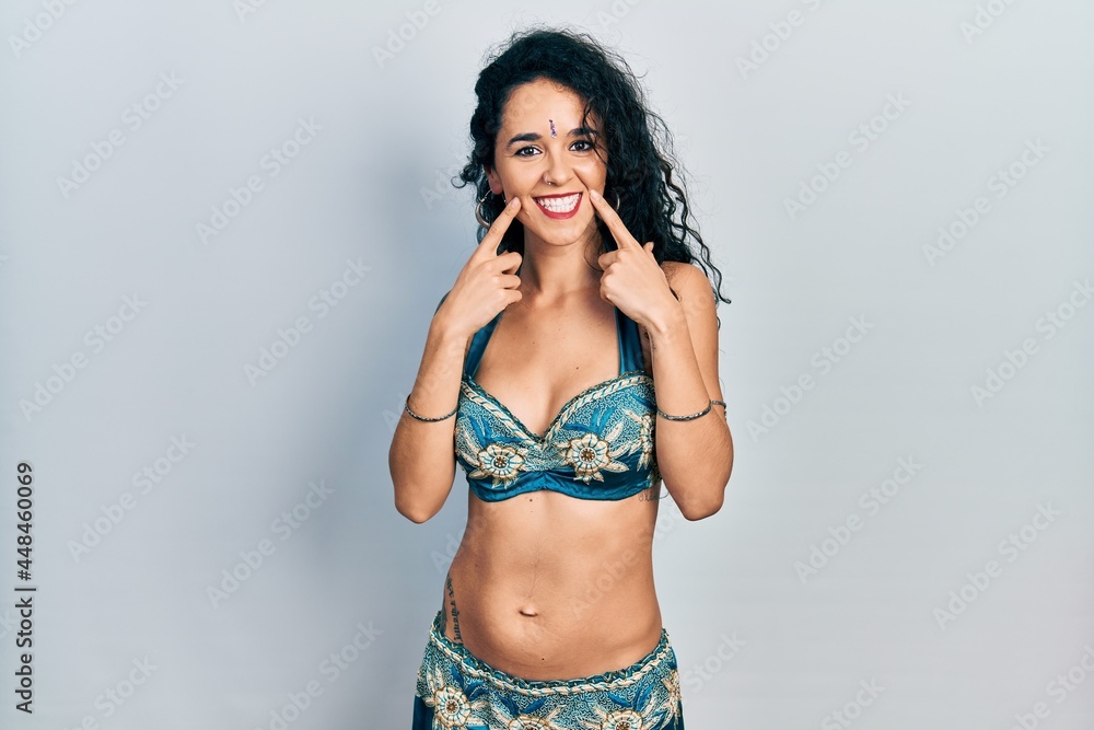 Young woman wearing bindi and traditional belly dance clothes smiling with open mouth, fingers pointing and forcing cheerful smile Young woman wearing bindi and traditional belly dance clothes smiling with open mouth, fingers pointing and forcing cheerful smile