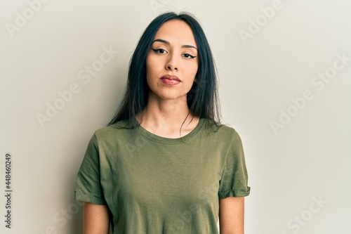 Young hispanic girl wearing casual t shirt relaxed with serious expression on face. simple and natural looking at the camera.