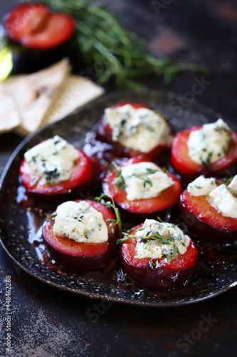Baked plums with blue cheese and thyme. Healthy snack. Keto food. 