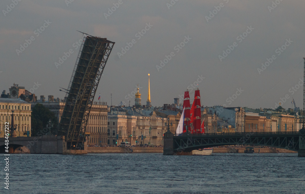 St. Petersburg, Russia. Evening panorama of Neva river.  Scarlet sailboat near open Trinity bridge. Spire of the Admiralty building Big zoom, telephoto