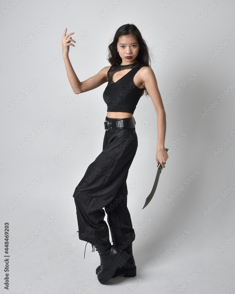 Full length portrait of pretty young asian girl wearing black tank top ...