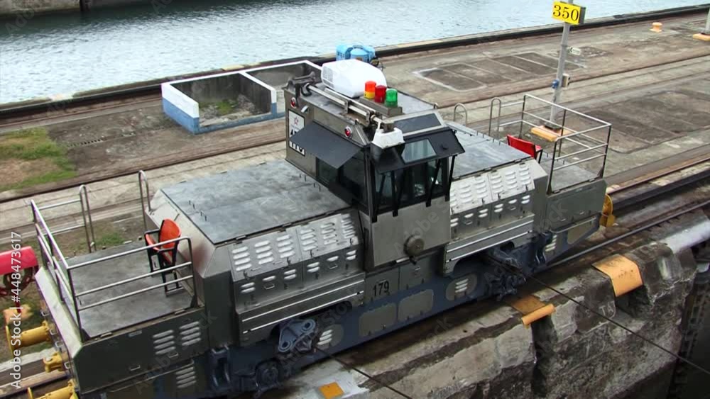 Top view of a electric locomotive pulling the ship at Panama Canal. Top view of a electric locomotive pulling the ship at Panama Canal.