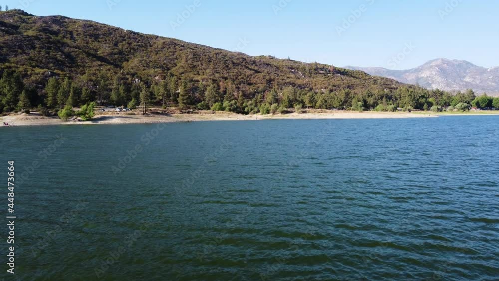 Lake Hemet and majestic mountain range in low angle flying over water Lake Hemet and majestic mountain range in low angle flying over water
