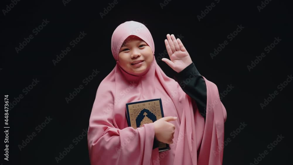 Asian Muslim Woman Standing And Reading The Quran And Appreciates And ...