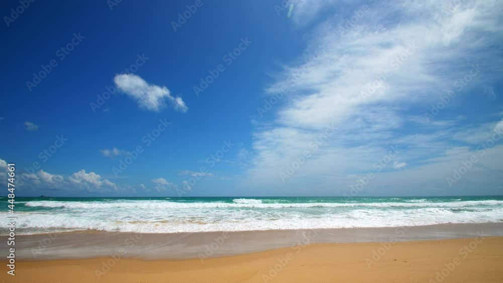 4K Beautiful tropical beach with blue sky and clouds. Tropical beach with waves crashing empty beach. Andaman Phuket beach Thailand. 4K Beautiful tropical beach with blue sky and clouds. Tropical beach with waves crashing empty beach. Andaman Phuket beach Thailand.